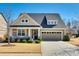 Charming single-Gathering home with landscaped front yard, welcoming front porch, and a two-car garage at 5316 Baker Ln, Clover, SC 29710