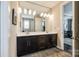 Bright bathroom features a double sink vanity with dark cabinets and a large mirror at 5316 Baker Ln, Clover, SC 29710