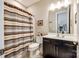 Cozy bathroom featuring a vanity, toilet, striped shower curtain, and neutral wall color at 5316 Baker Ln, Clover, SC 29710