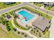 Aerial view of a community pool with ample seating, umbrellas, a clubhouse, and a nearby playground at 5316 Baker Ln, Clover, SC 29710