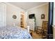Bright bedroom with hardwood floors, dresser, and a view into the hallway at 5316 Baker Ln, Clover, SC 29710