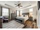 Serene main bedroom with tray ceiling, ceiling fan, large windows, and a seating area at 5316 Baker Ln, Clover, SC 29710