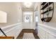 Spacious foyer with a decorative rug, paneled walls, and a shelf with decorative accents at 5316 Baker Ln, Clover, SC 29710
