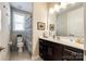 Well-lit bathroom featuring dark wood cabinets, a white marble countertop, and a decorative shower curtain at 5316 Baker Ln, Clover, SC 29710