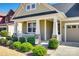 Inviting front porch features white columns, a white picket fence, and verdant landscaping at 5316 Baker Ln, Clover, SC 29710