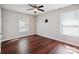 A bright bedroom with wood floors, two windows, and a modern ceiling fan at 544 Castlewood Cir, Rock Hill, SC 29730