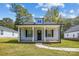 Charming home featuring a covered front porch with white columns and a well-maintained lawn at 544 Castlewood Cir, Rock Hill, SC 29730
