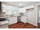 Bright kitchen featuring white cabinets, granite countertops, stainless steel appliances and wood floors at 544 Castlewood Cir, Rock Hill, SC 29730