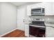 Bright kitchen featuring white cabinets, granite countertops, stainless steel appliances and wood floors at 544 Castlewood Cir, Rock Hill, SC 29730