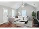 Bright living room with vaulted ceiling, ceiling fan, wood floors and large sectional sofa at 544 Castlewood Cir, Rock Hill, SC 29730