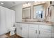 Bathroom featuring dual sinks with framed mirrors, a shower and tiled floors at 582 Sixth Baxter Xing, Fort Mill, SC 29708