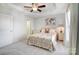 Well-lit bedroom with a ceiling fan, a white-painted bed, and a neutral color scheme at 582 Sixth Baxter Xing, Fort Mill, SC 29708