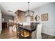 The dining room has hardwood floors, wainscoting, and a modern chandelier at 582 Sixth Baxter Xing, Fort Mill, SC 29708
