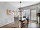 Dining room area with modern light fixture and wainscoting on the walls at 582 Sixth Baxter Xing, Fort Mill, SC 29708