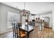 Open dining room with a modern chandelier and views of the kitchen at 582 Sixth Baxter Xing, Fort Mill, SC 29708