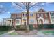 Charming townhouse exteriors with landscaped front yards, covered entrances, and appealing architectural details at 582 Sixth Baxter Xing, Fort Mill, SC 29708