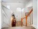 Elegant foyer with wainscoting, hardwood floors, a staircase with wood railing, and ample natural light at 582 Sixth Baxter Xing, Fort Mill, SC 29708