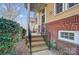 Inviting front porch with brick accents, wrought iron railings, and a welcoming entrance at 582 Sixth Baxter Xing, Fort Mill, SC 29708