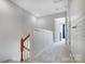 Upstairs hallway featuring neutral carpeting, white walls, and classic wood railing at 582 Sixth Baxter Xing, Fort Mill, SC 29708