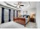 Comfortable bedroom featuring a trey ceiling, ceiling fan and large window offering great natural light at 582 Sixth Baxter Xing, Fort Mill, SC 29708