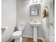 Stylish powder room with pedestal sink and wood look floors at 582 Sixth Baxter Xing, Fort Mill, SC 29708