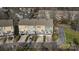 An aerial view of townhouses highlighting rear decks, backyard patios, and convenient parking spaces at 582 Sixth Baxter Xing, Fort Mill, SC 29708