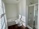 Bright bathroom with a soaking tub and a glass shower, showcasing natural light at 5905 Waverly Lynn Ln, Charlotte, NC 28269