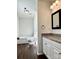 Bathroom boasts granite countertop, white vanity, toilet, and a shower-tub combo at 5905 Waverly Lynn Ln, Charlotte, NC 28269