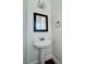 Elegant powder room featuring a pedestal sink and classic mirror design at 5905 Waverly Lynn Ln, Charlotte, NC 28269