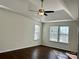 Bright bedroom boasts tray ceiling, fan, two windows, and durable flooring at 5905 Waverly Lynn Ln, Charlotte, NC 28269