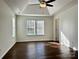Bright bedroom boasts durable flooring, a ceiling fan, and natural light from two windows at 5905 Waverly Lynn Ln, Charlotte, NC 28269