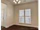 This well-lit dining room features elegant hardwood floors, large windows, and modern lighting fixture at 5905 Waverly Lynn Ln, Charlotte, NC 28269