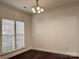 This well-lit dining room features elegant hardwood floors, large windows, and modern lighting fixture at 5905 Waverly Lynn Ln, Charlotte, NC 28269