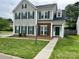 Two-story home with gray siding, brick accents, and complementary green shutters and front door at 5905 Waverly Lynn Ln, Charlotte, NC 28269