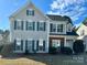 Charming two-story home with gray siding, dark shutters, and a well-manicured lawn in a desirable neighborhood at 5905 Waverly Lynn Ln, Charlotte, NC 28269
