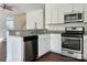 Well-lit kitchen featuring stainless steel appliances, white cabinets, and beautiful granite countertops at 5905 Waverly Lynn Ln, Charlotte, NC 28269