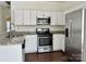 Well-lit kitchen with stainless steel appliances and white cabinets with granite countertops at 5905 Waverly Lynn Ln, Charlotte, NC 28269