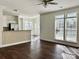 Open-concept living room with seamless flow to the kitchen, featuring hardwood floors and ample natural light at 5905 Waverly Lynn Ln, Charlotte, NC 28269