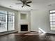 Bright living room featuring a cozy fireplace, hardwood floors, and large windows, ideal for relaxation at 5905 Waverly Lynn Ln, Charlotte, NC 28269