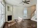 Bright living room featuring a cozy fireplace, hardwood floors, and large windows, ideal for relaxation at 5905 Waverly Lynn Ln, Charlotte, NC 28269