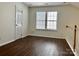 Well-lit loft area with ample space and hardwood flooring, offering versatile use as a home office or play area at 5905 Waverly Lynn Ln, Charlotte, NC 28269