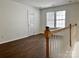Spacious loft area with natural light, perfect as a flexible living space with durable hardwood flooring at 5905 Waverly Lynn Ln, Charlotte, NC 28269