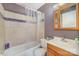 Bathroom features a vanity, mirror, and bathtub with shower at 6817 Fieldlark Ln, Charlotte, NC 28227