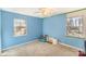 Freshly painted bedroom with carpet flooring and two large windows offering ample natural light at 6817 Fieldlark Ln, Charlotte, NC 28227