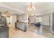 Open-concept kitchen flows into a bright living area with modern lighting at 6817 Fieldlark Ln, Charlotte, NC 28227