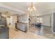 Open-concept kitchen flows into a bright living area with modern lighting at 6817 Fieldlark Ln, Charlotte, NC 28227