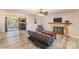 Inviting living room features a stone fireplace, ceiling fan, and wood-look flooring at 6817 Fieldlark Ln, Charlotte, NC 28227