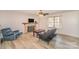Comfortable living room featuring a stone fireplace, ceiling fan, and natural light at 6817 Fieldlark Ln, Charlotte, NC 28227