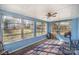 Relaxing sun room featuring large windows offering ample natural light and views of the fenced backyard at 6817 Fieldlark Ln, Charlotte, NC 28227