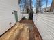 Fenced backyard area featuring wood plank fencing, green door, and mature trees at 7140 Stonington Ln, Charlotte, NC 28227